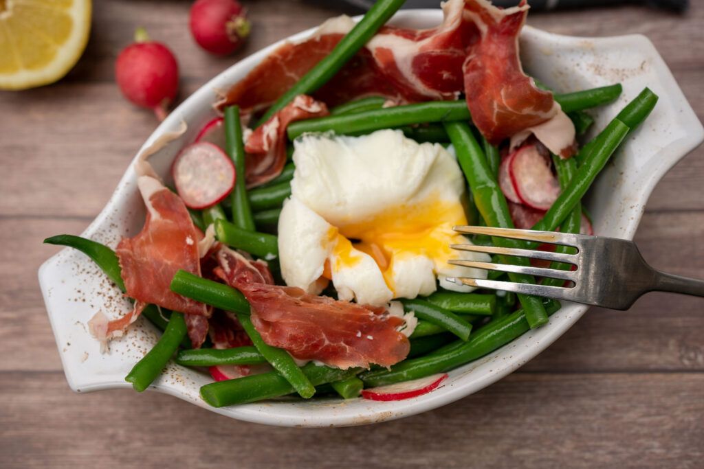 Beans with poached egg and Iberian ham