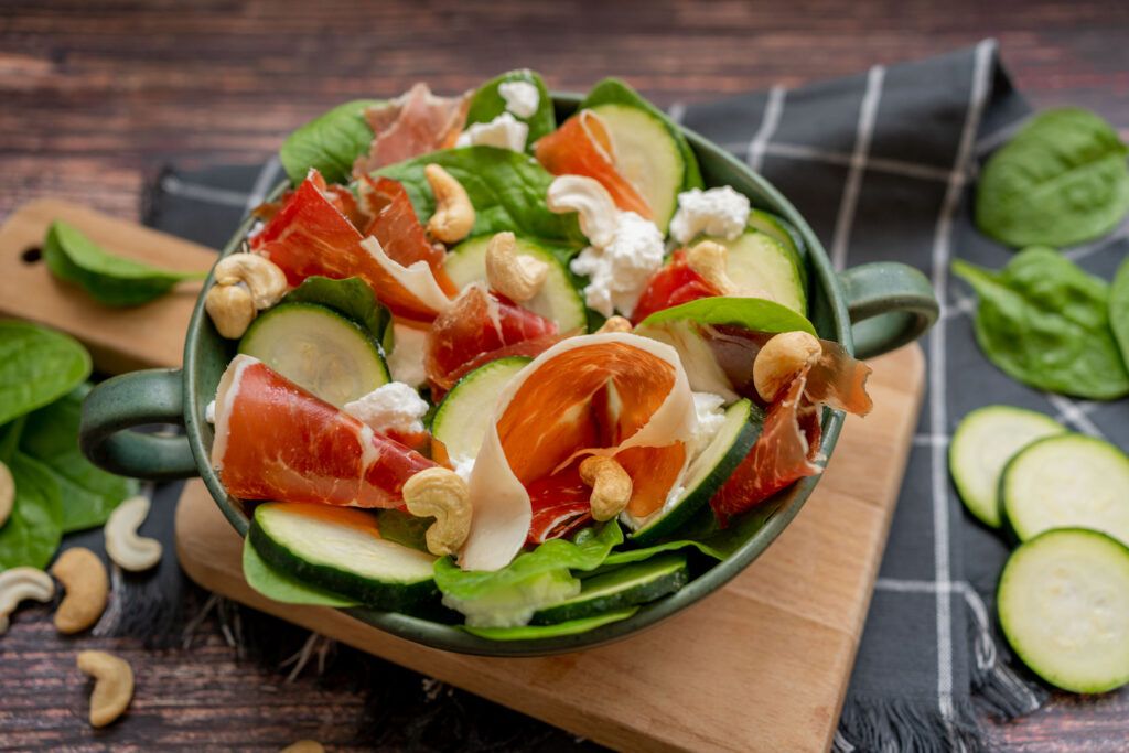 Spinach leaf salad with zucchini, ricotta, and ham